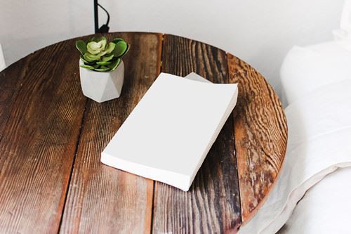 Canva - White Book on Brown Round Table_
